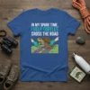 In My Spare Time, I Help Turtles Cross The Road quote on a blue t-shirt, featuring a turtle being helped