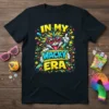 In My Wacky Era text with a cartoon character wearing sunglasses and a colorful explosion graphic on a black t-shirt