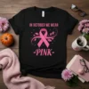 Black t-shirt with "In October We Wear Pink" text and a pink ribbon graphic for breast cancer awareness