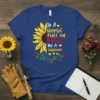 In A World Full of Roses Be A sunflower text design with a half sunflower and roses graphic on a