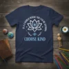 Navy t-shirt with white and light blue text "In A World Where You Can Be Anything Choose Kind" and a