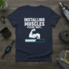 Installing Muscles Please Wait humorous gym t-shirt design featuring a flexing arm and progress bar