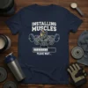 Installing Muscles Please Wait T-Shirt with a muscular rhino lifting weights and a progress bar graphic