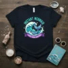 Instant Mermaid Just Add Water text with a blue mermaid tail and turquoise wave graphic on a navy t-shirt