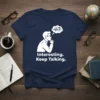 Navy blue t-shirt with white text "Interesting. Keep Talking." and a graphic of a man thinking