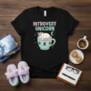 Introvert Unicorn T-Shirt with a cute sleeping unicorn inside a teacup, pastel colors, text "INTROVERT UNICORN"