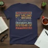 Navy t-shirt with bold retro typography: "INTROVERTED BUT WILLING TO DISCUSS DISMANTLING SYSTEMS OF OPPRESSION" and a graphic of a
