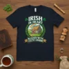 Irish In Heart Blessed With Celtic Charm T-Shirt featuring an illustration of an Irish cottage with a rainbow and shamrocks