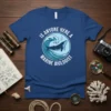 Is Anyone Here A Marine Biologist quote on a blue t-shirt with a whale in waves graphic
