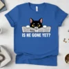 Funny cat reading a newspaper with the text "Is He Gone Yet?" in white, bold font on a blue t-shirt