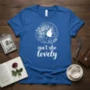 Isn't She Lovely quote with a white floral design of a woman's profile on a blue t-shirt