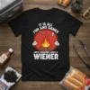 Black t-shirt with "IT IS ALL FUN AND GAMES UNTIL SOMEONE LOSES A WIENER" text and cartoon campfire graphic