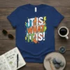 Bold "IT IS WHAT IT IS!" text design with colorful abstract shapes and lightning bolts on a navy t-shirt