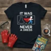 Navy t-shirt with white text "IT WAS NEVER A DRESS" and graphics of a dress and a running superhero