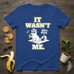 It Wasn't Me. funny cat t-shirt design with a cool cat holding a banana and smoking, a palm tree, and