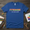ITEMIE Our True Colors text in rainbow gradient with white outline on a royal blue t-shirt