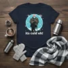 T-shirt design with Bernie Sanders sitting in the cold wearing mittens and a mask, with the text "its cold eh!"