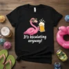 Black t-shirt with cartoon pink flamingo wearing sunglasses and holding a beer, text reads "It's escalating anyway!"