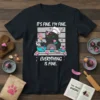 Black cat wearing chef hat covered in frosting, holding cupcakes, with text "IT'S FINE. I'M FINE. EVERYTHING IS FINE."