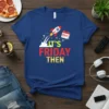 It's Friday Then t-shirt with a red, white, and blue rocket launching with question marks and a calendar icon