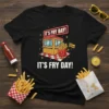 Black t-shirt with "It's Fry Day!" text and a cartoon french fry character holding a flag