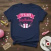 Navy blue t-shirt with pink text "IT'S HIS birthday" and a graphic of a present with party poppers