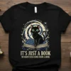 Black cat sitting on an open book with the quote "It's Just A Book No Harm Ever Came From A