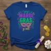 It's Mardi Gras y'all t-shirt with purple, green, and gold text and a festive mask graphic