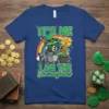 St. Patrick's Day t-shirt with green text "IT'S ME I AM THE SHEnagians" and a raccoon wearing a hat holding