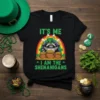 St. Patrick's Day t-shirt with "IT'S ME I AM THE SHENANIGANS" text, featuring a raccoon holding beer mugs, pots of