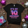 Black t-shirt with "IT'S MY 10 BIRTHDAY #Double Digits" design, featuring a crown, number 10 with constellations, and pink/blue gradient