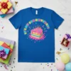 It's My 8th Birthday! text with a rainbow layer cake graphic, candles, and colorful splashes on a blue t-shirt