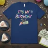 It's My Birthday Pin Money Here T-Shirt with confetti, money, and party popper graphic on navy blue
