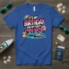 It's My Birthday And My First Cruise text with cruise ship and birthday cake graphic on a blue t-shirt