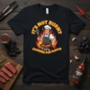 It's Not Burnt It's Charred For Flavor funny grilling quote on a black t-shirt with a chef character at a