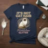 It's Not Cat Hair It's Himudan Glitter text with a seated Himudan cat graphic on a navy t-shirt