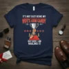 Humorous husband t-shirt with text "It's Not Easy Being My Wife's Arm Candy But Here I Am Nailing It" and