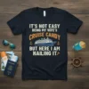 Navy t-shirt with "It's Not Easy Being My Wife's Cruise Candy But Here I Am Nailing It" text and a