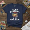 White text "IT'S NOT HOARDING IF IT'S COMIC BOOKS" with a stack of colorful comic books on a navy blue