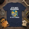 T-shirt with "IT'S NOT HOARDING IF IT'S TOOLS" text and graphics of drills and a circular saw