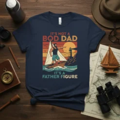 It's Not a Bod Dad It's a Father Figure quote on a navy t-shirt with a sailing man graphic