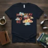 It's Okay To Not Be Okay quote on a dark navy t-shirt with colorful cloud graphics and small heart detail