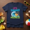 It's Summer Madness text and graphic with a crashing wave and colorful splashes on a navy blue t-shirt