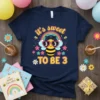 Navy t-shirt with "it's sweet TO BE 3" text, featuring a cute bee wearing heart sunglasses and a rainbow graphic