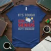 T-shirt with "IT'S TOUGH BEING A GENIUS BUT I MANAGE" text in gray and red, featuring a brain graphic with