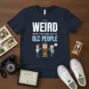 T-shirt with the text "IT'S WEIRD BEING THE SAME AGE AS OLD PEOPLE" and a cartoon graphic of a young