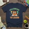 It's a Good Day to Learn quote on a navy t-shirt with a cartoon owl reading a book, holding a