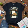Graphic t-shirt with the quote "It's A Good Day To Make Some Art" featuring an easel, palette, and paintbrush design