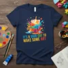 T-shirt with colorful paint splatters, an easel, and the text "It's a Good Day To Make Some Art" for artists