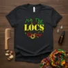 It's The LOCS for me text design with stylized loc graphics in yellow, green, and red on a black t-shirt